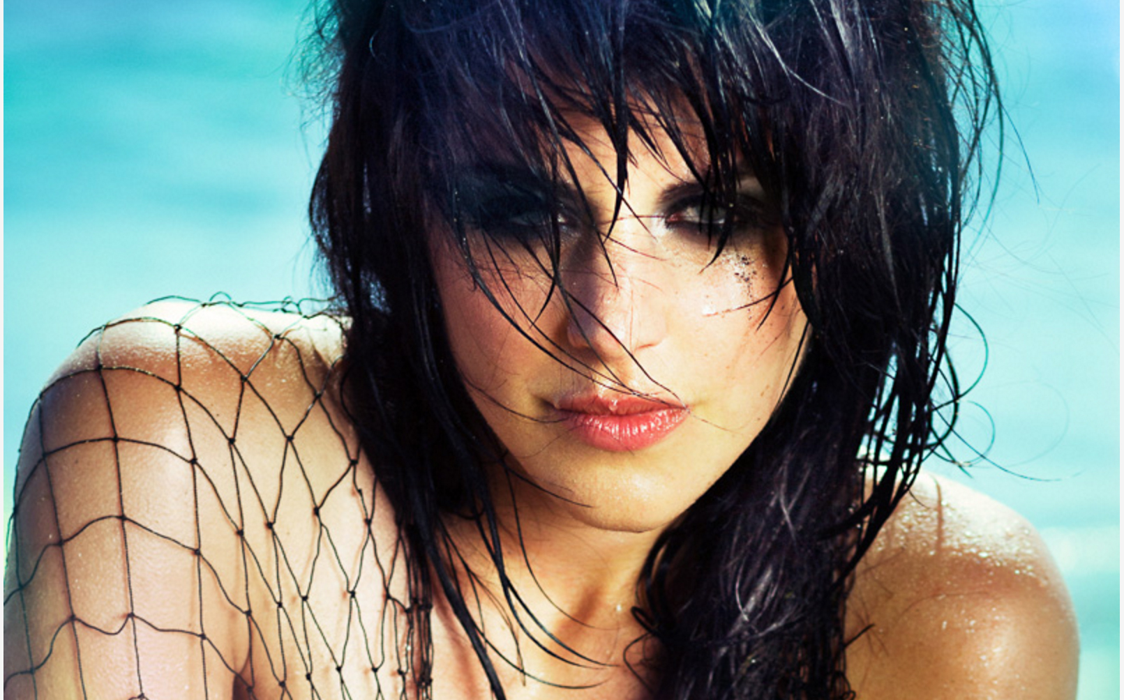 Close-up model with wet hair on beach