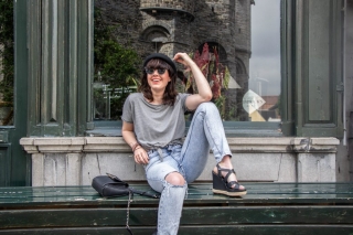 Model sitting outside with sunglasses