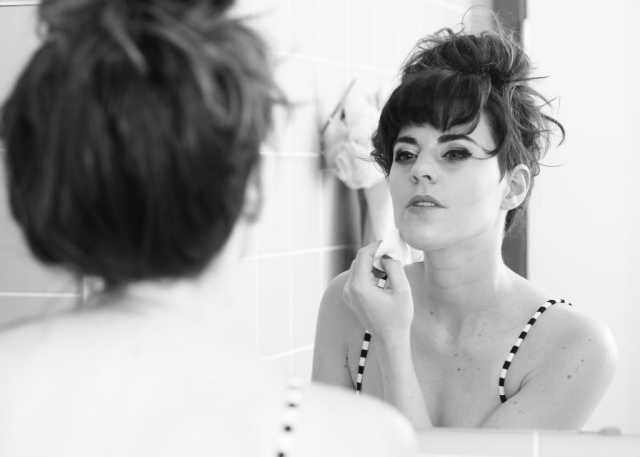 Model looking in mirror